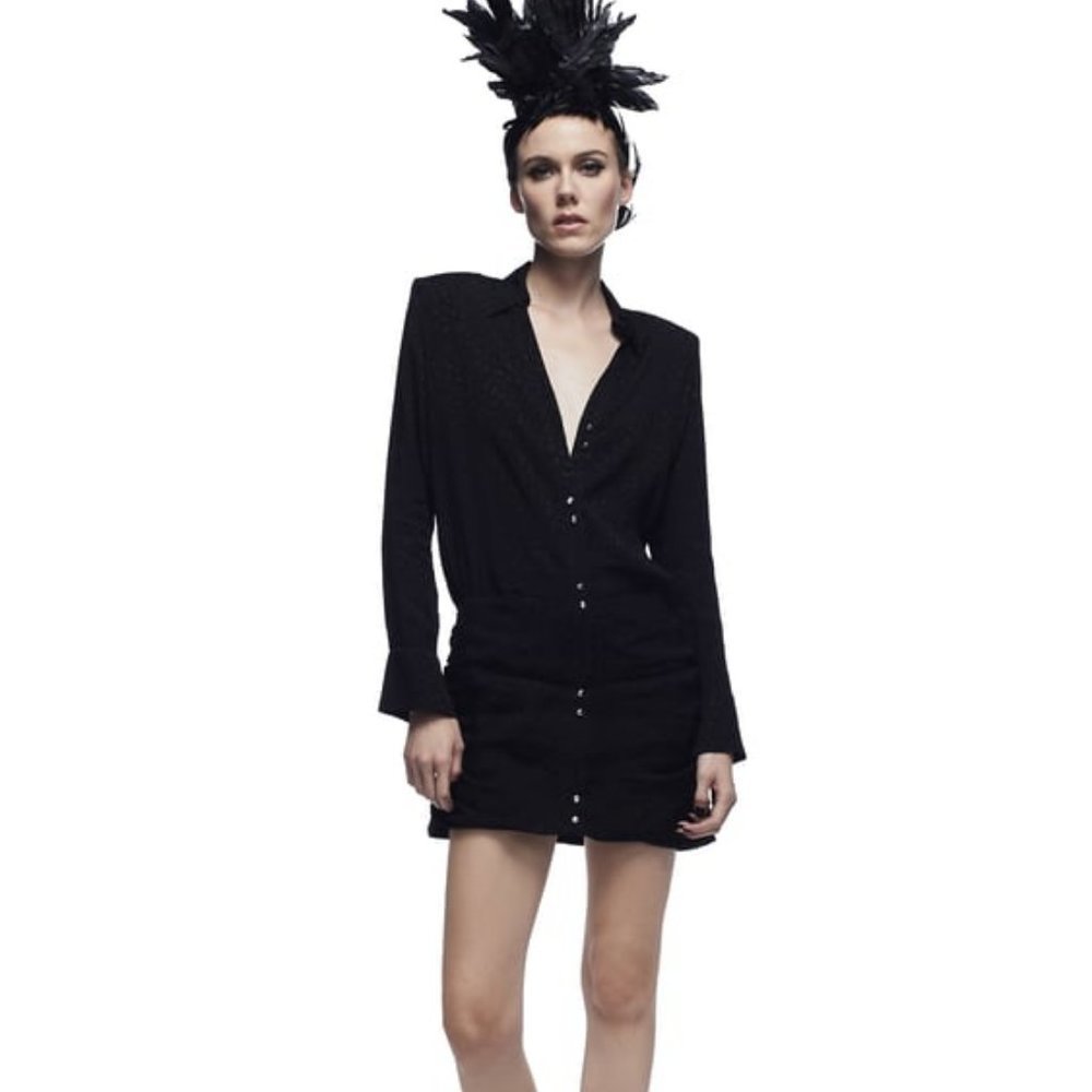 Collared dress featuring long sleeves with a buttoned opening. Gathered hem and